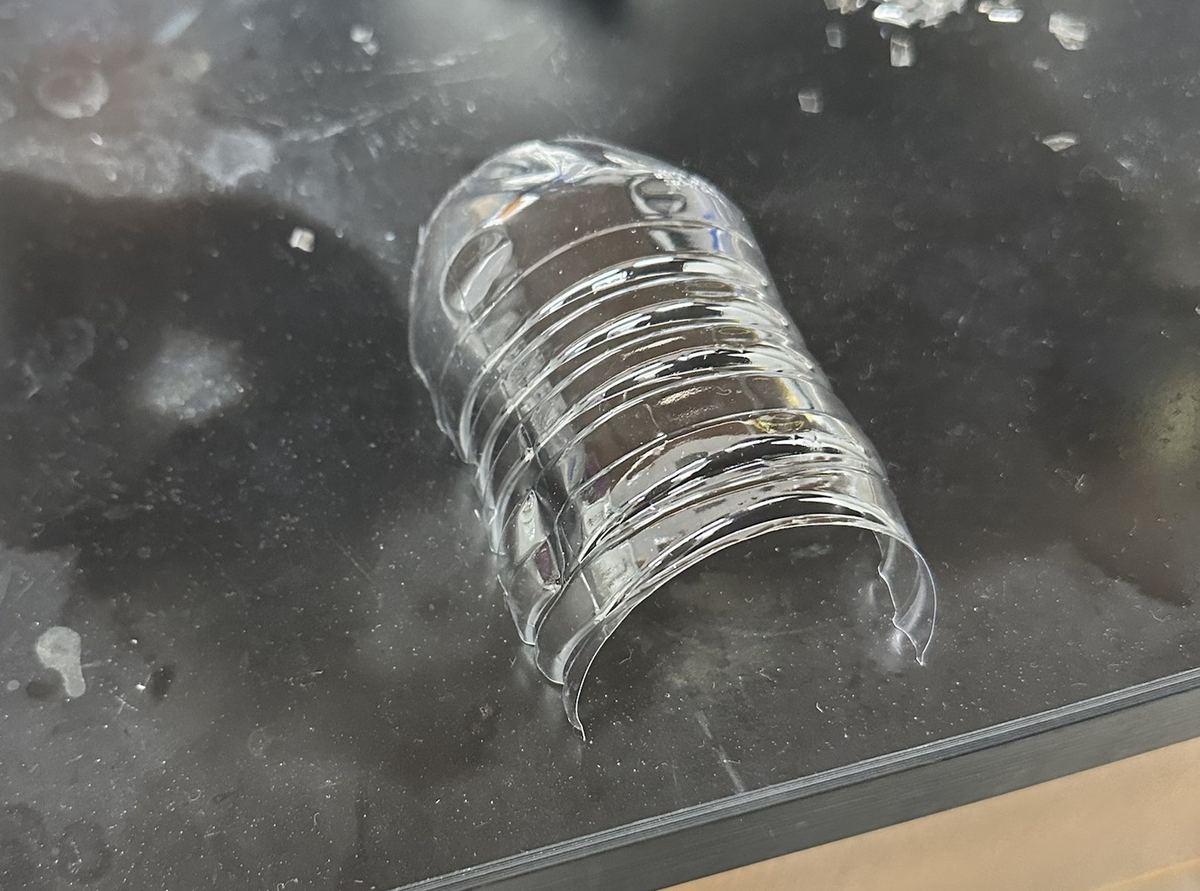 The water bottle cut open on a lab bench